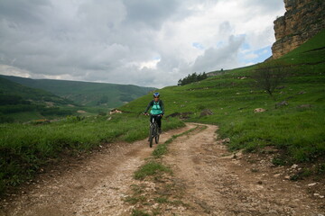 A cyclist rides in the Caucasus mountains.
