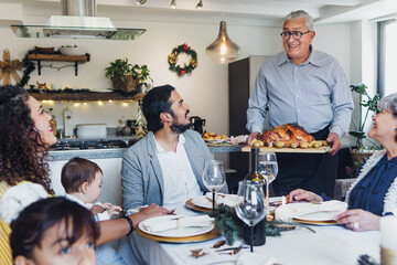 Latin family having thanksgiving dinner at home in Mexico Latin America, hispanic people eating at...