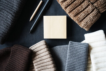 Notepad next to cozy knitted items