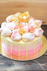 Gradient pink birthday cake with meringue clouds, chocolate stars, donuts and golden fondant crown...
