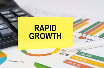 On business reports there is a calculator and a sign with the inscription - rapid growth