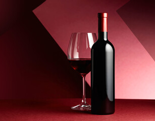 Bottle and glass of red wine.