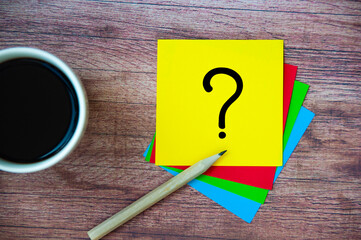 Top view of question mark on notepad. Question and answer concept