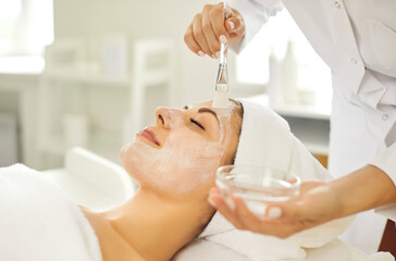 Woman getting professional skin facial care treatment procedures at spa and beauty salon. Young...