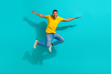 Obraz premium Full body photo of overjoyed cheerful young person jumping flying have good mood isolated on bright teal color background