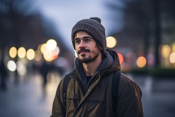 young handsome bearded hipster man in the city at night in winter
