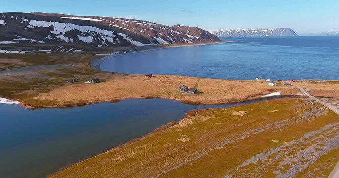 Aerial view of village of Store Molvik on the shore of Barents Sea in sunny summer weather, Varanger Peninsula, Norway.