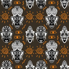 Seamless pattern of African masks and spirals on a brown background.