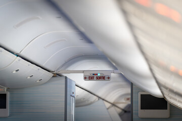 Exit sign lightbox  in passenger airplane, escape way of life. way to survive concept
