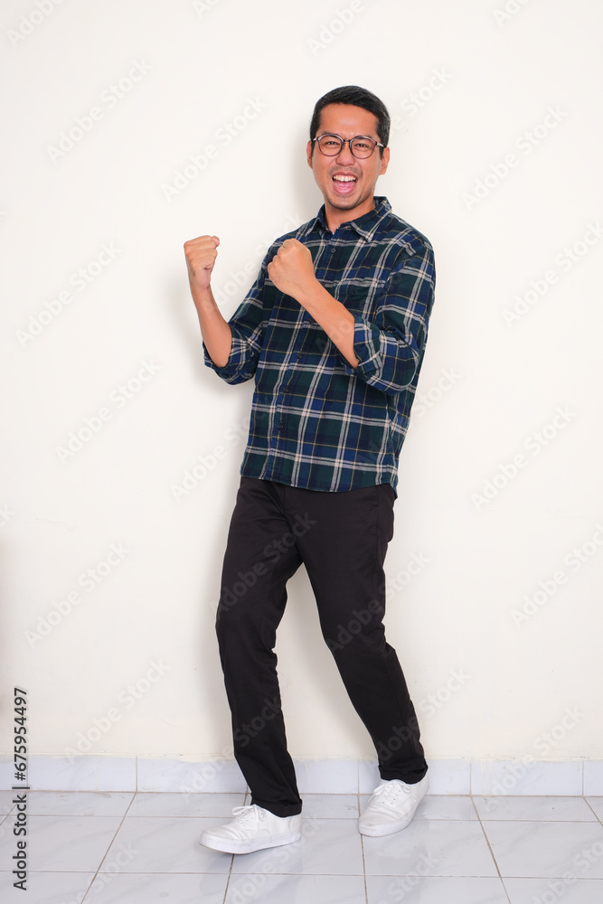 Wall mural Full body portrait of a man standing with excited expression - Wall murals