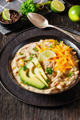 white chicken chili with cheese, avocado in bowl