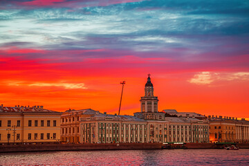 Fantastic fiery sunset over the Neva River. Kunstkamera building.