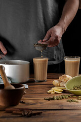 A man pours a traditional Indian drink, masala chai.