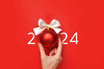An unusual inscription 2024 with a Christmas ball. A symbol of the upcoming merry new year