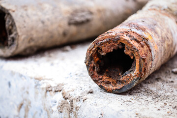 Detail shot with old and rusty drinking water pipes - 675961296