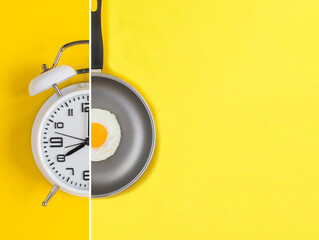 Collage of white alarm clock and frying pan with fried egg on the yellow background. Top view.Copy space.