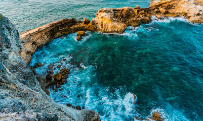 Cliffs and ocean breaking on rocks seen from Pointe des Chateaux, Saint-François, Guadeloupe,...