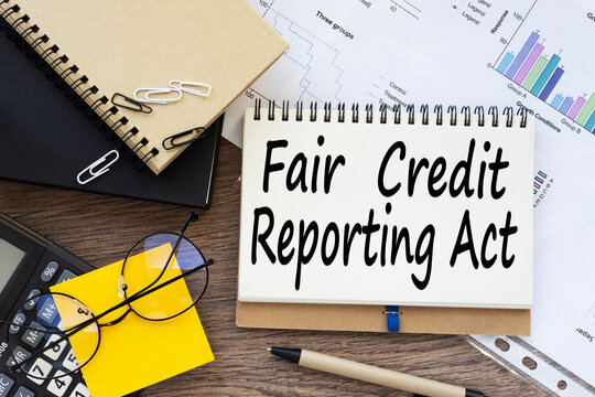 Fair credit reporting act FCRA on a desk. yellow sticker on the calculator. financial charts. text on the envelope