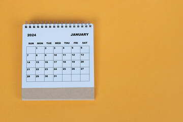 January 2024 desk calendar on yellow background. Directly above. Flat lay.
