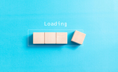 Loading, wood block in progress bar on blue background for download software and waiting to loading...