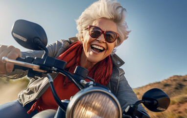 Fototapeta na wymiar An elderly woman with a joyful look speeds by on her motorbike