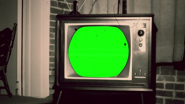 Retro Television Green Screen Zoom In Vintage TV Inside Old House. Old television with green screen, for replacement, inside a vintage house, zoom in. Old film texture