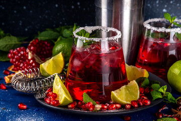 Pomegranate mocktail or cocktail, Boozy alcohol pomegranate and lime drink, lemonade, mojito, margarita with frozen rim