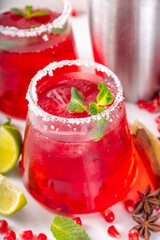 Pomegranate mocktail or cocktail, Boozy alcohol pomegranate and lime drink, lemonade, mojito, margarita with frozen rim