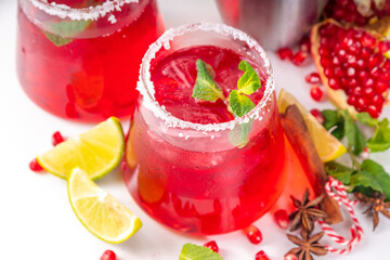 Pomegranate mocktail or cocktail, Boozy alcohol pomegranate and lime drink, lemonade, mojito, margarita with frozen rim