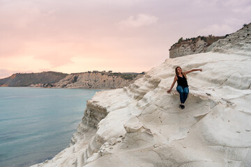 Tourist admiring the white limestone cliffs of the Scala dei Turchi, Agrigento, Sicily, Italy, 