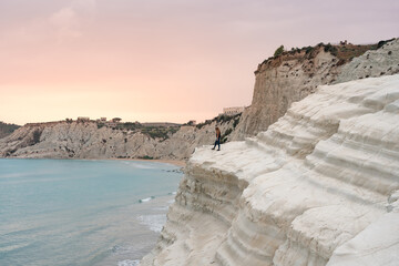 Tourist admiring the white limestone cliffs of the Scala dei Turchi, Agrigento, Sicily, Italy, 