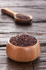 Brown organic quinoa seeds in the bowl and spoon - Chenopodium quinoa​