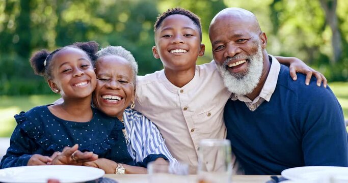 Happy, nature and grandparents with children at a picnic for family time and bonding in a garden. Smile, portrait and African senior man and woman in retirement embracing kids in the park together.