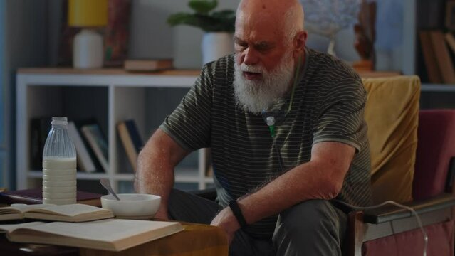 Old man stay in chair and prepare dinner. Old sick man is home alone. Concept of medical curation of various virus diseases.