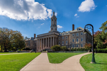 The Old Main building on the campus of  Pennsylvania State University in summer sunny day, State College, Pennsylvania. - 675998294