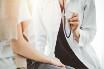 Doctor and a kid patient. Physician is holding stethoscope and ready to examine boy. Perfect health concept in medicine