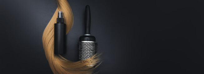 Blond shiny hair wave, Round brush for styling hair and Hair care spray, on black background. Hairdresser service, hair strength, haircut, hairstyle. Concept hairdresser spa salon.
