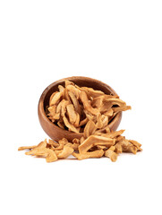 Dried apple slices spill out of a bowl onto a white background.