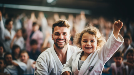 Digital photo of a child celebrating a victory in a judo competition together with the coach - obrazy, fototapety, plakaty