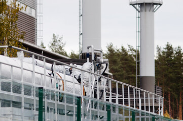 pipelines close-up on the background of an industrial plant and gray sky