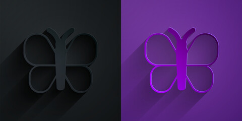 Paper cut Butterfly icon isolated on black on purple background. Paper art style. Vector