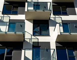 Glass balconies, windows, architecture details of modern house building, new block of flats. Condominium, real estate