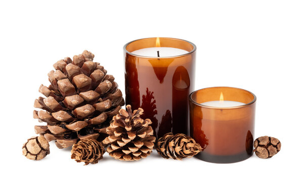 natural Christmas / holiday decoration design element, various pine and cypress cones and two burning candles in amber glass jars isolated over a transparent background, eco friendly home decor, PNG