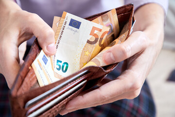 man hand putting money, closeup