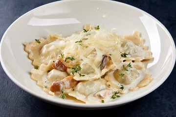ravioli with parmesan on the dark background