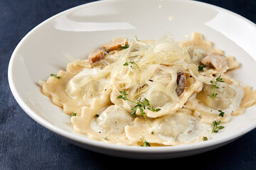 ravioli with parmesan on the dark background