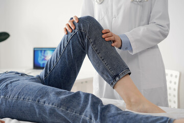 Doctor and patient are at the usual medical inspection in the clinic. Therapist examines a young woman's knee. Medicine concept