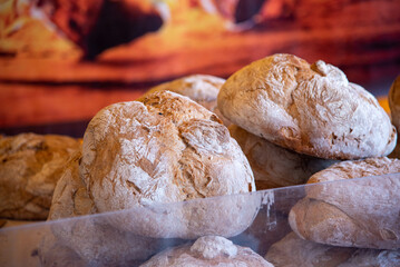 Detail shot of loaves of bread placed one on top of the other in a street market of food and artisanal products of the Mediterranean diet.