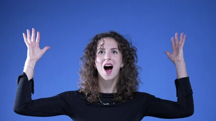 Funny Woman Mimicking Head Explosion on Blue Background, Shocked Yet Amused having a breakthrough idea, feeling enlightened