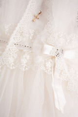 Close up of baby baptism dress with cross